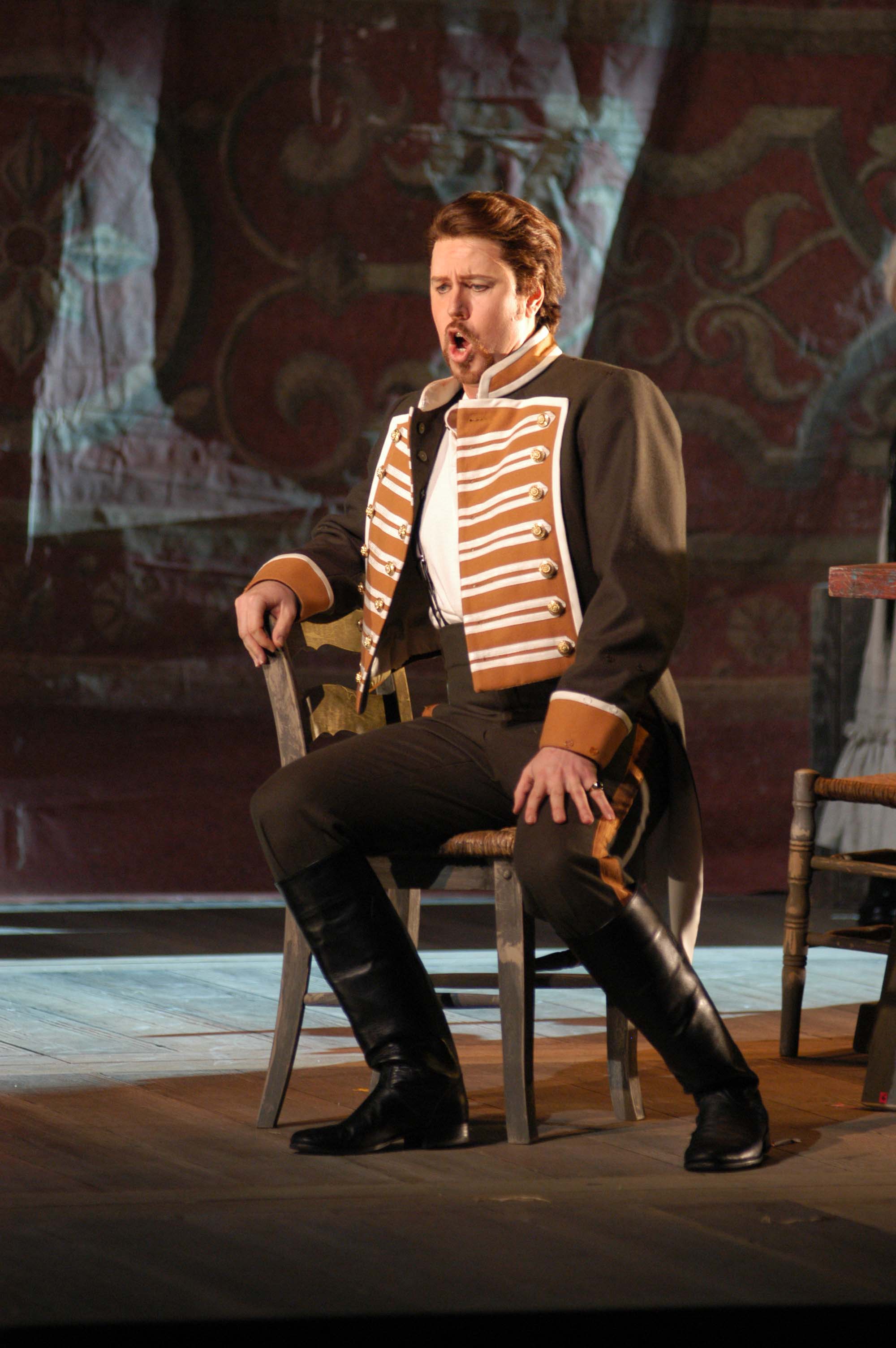 Thomas Truhitte as Don José, seated in military costume